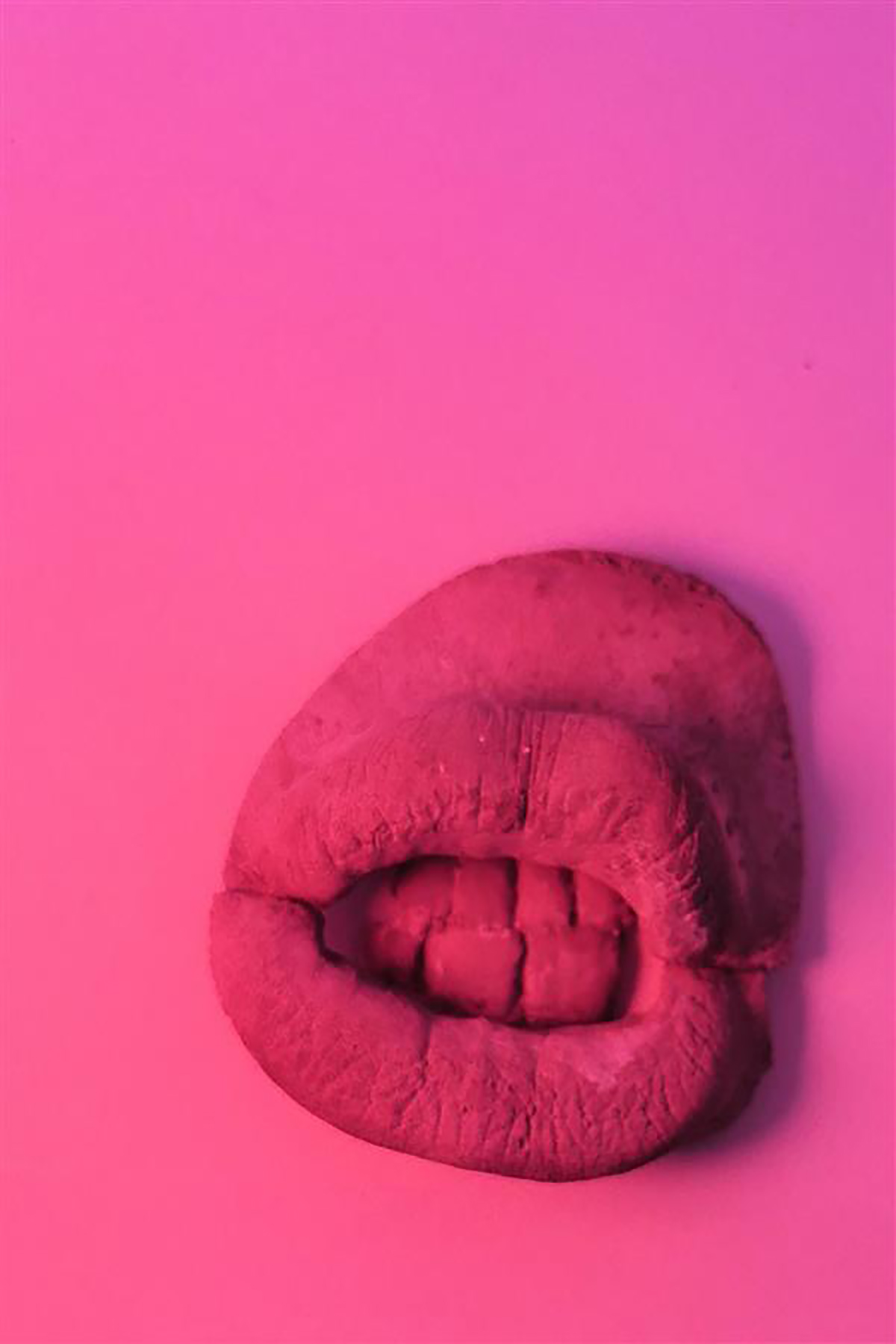 give us a smile luv by Kate McSharry, 10x10x5cm, cast concrete.